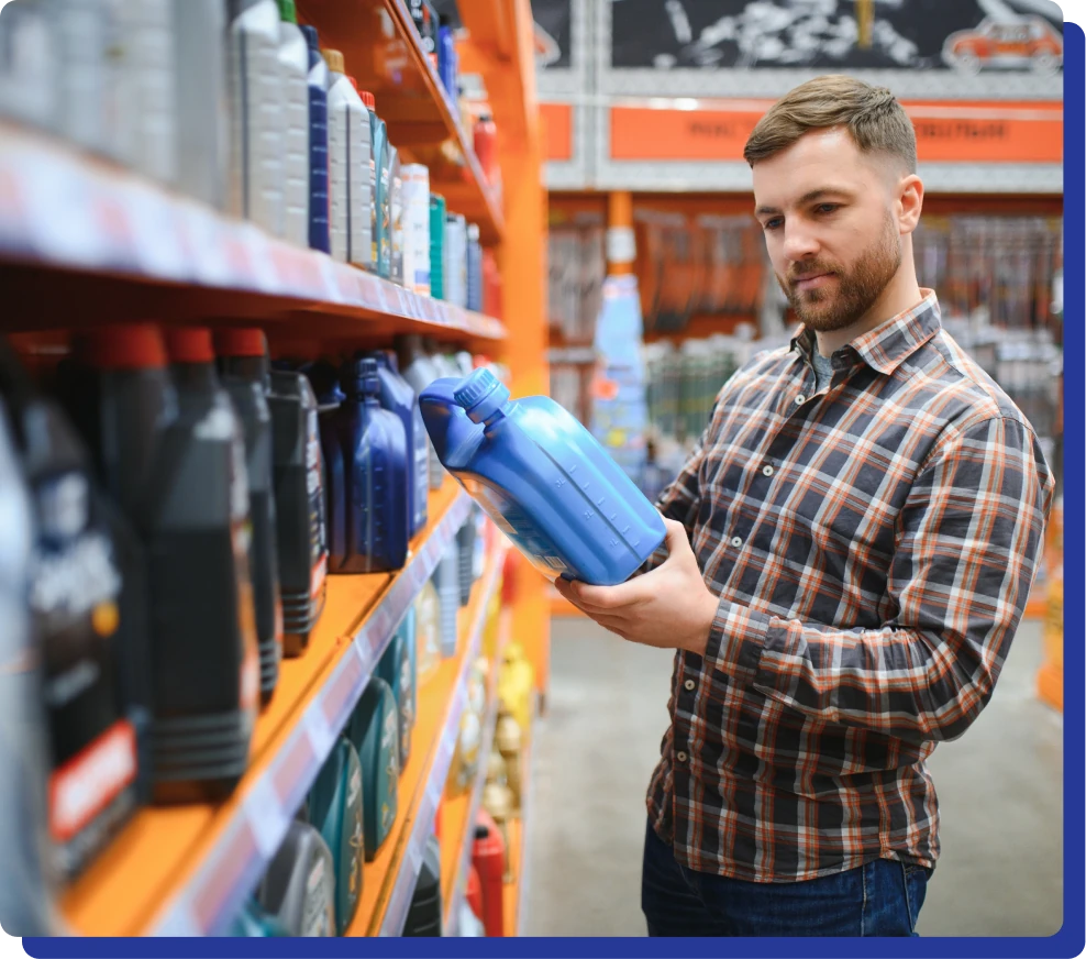 a man holding a blue canister in a store