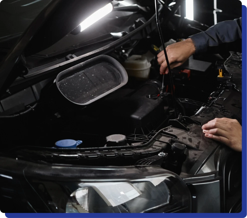 Fleet Maintenance in Kodiak, AK at Midtown Auto Repair Services. Mechanic working on a car engine under a hood with tools in hand.