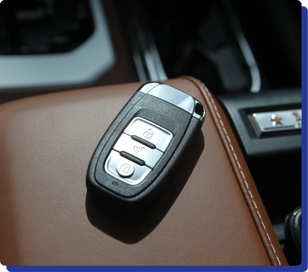 Key Fob Programming Services in Kodiak, AK at Midtown Auto Repair Services. A car key on a leather armrest