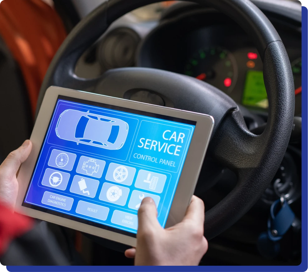 a person holding a tablet in front of a steering wheel