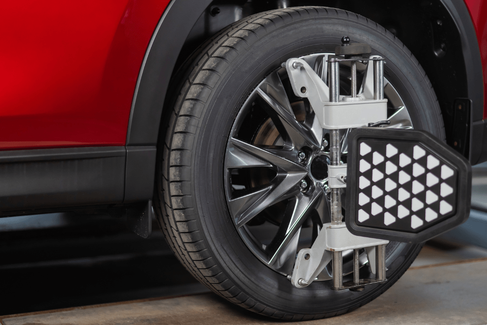 what is wheel alignment, auto repair in Kodiak, AK at Midtown Auto Repair Services. Image of a red vehicle with precision alignment equipment attached to the wheel.