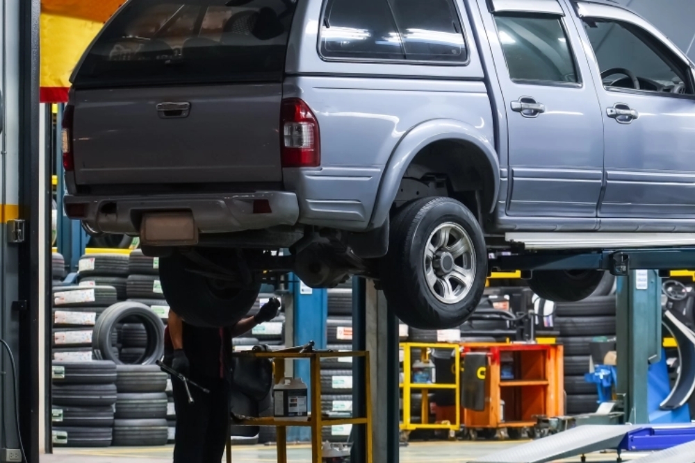 SUV on hydraulic lift at auto repair shop in Kodiak, AK. Car Dealership Overcharging, Overcharged for Auto Repairs In Kodiak, AK At Midtown Auto Repair Services